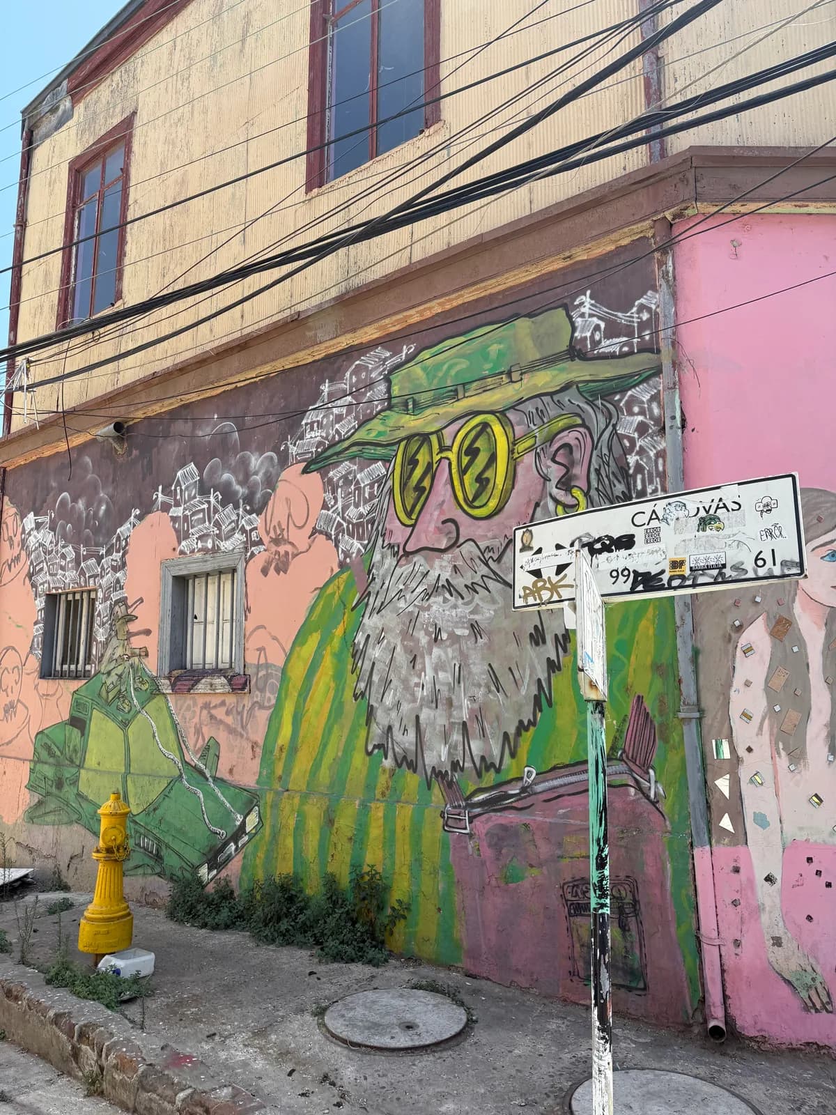 Large murals on outdoor stairways and walls in Valparaíso